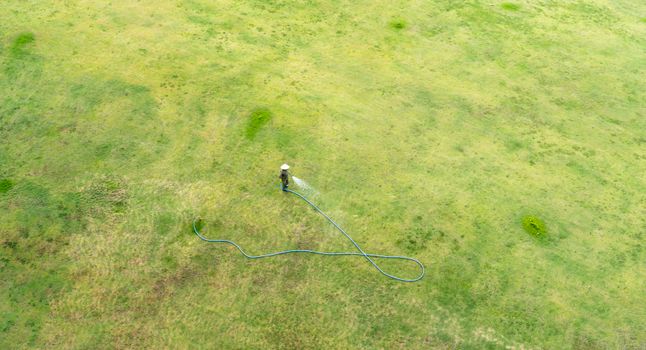 Aerial view of a man watering a field