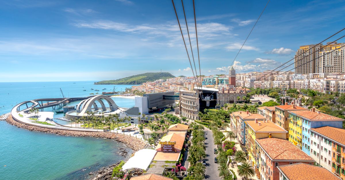 Vibrant coastal cityscape featuring modern architecture and blue seashore.
