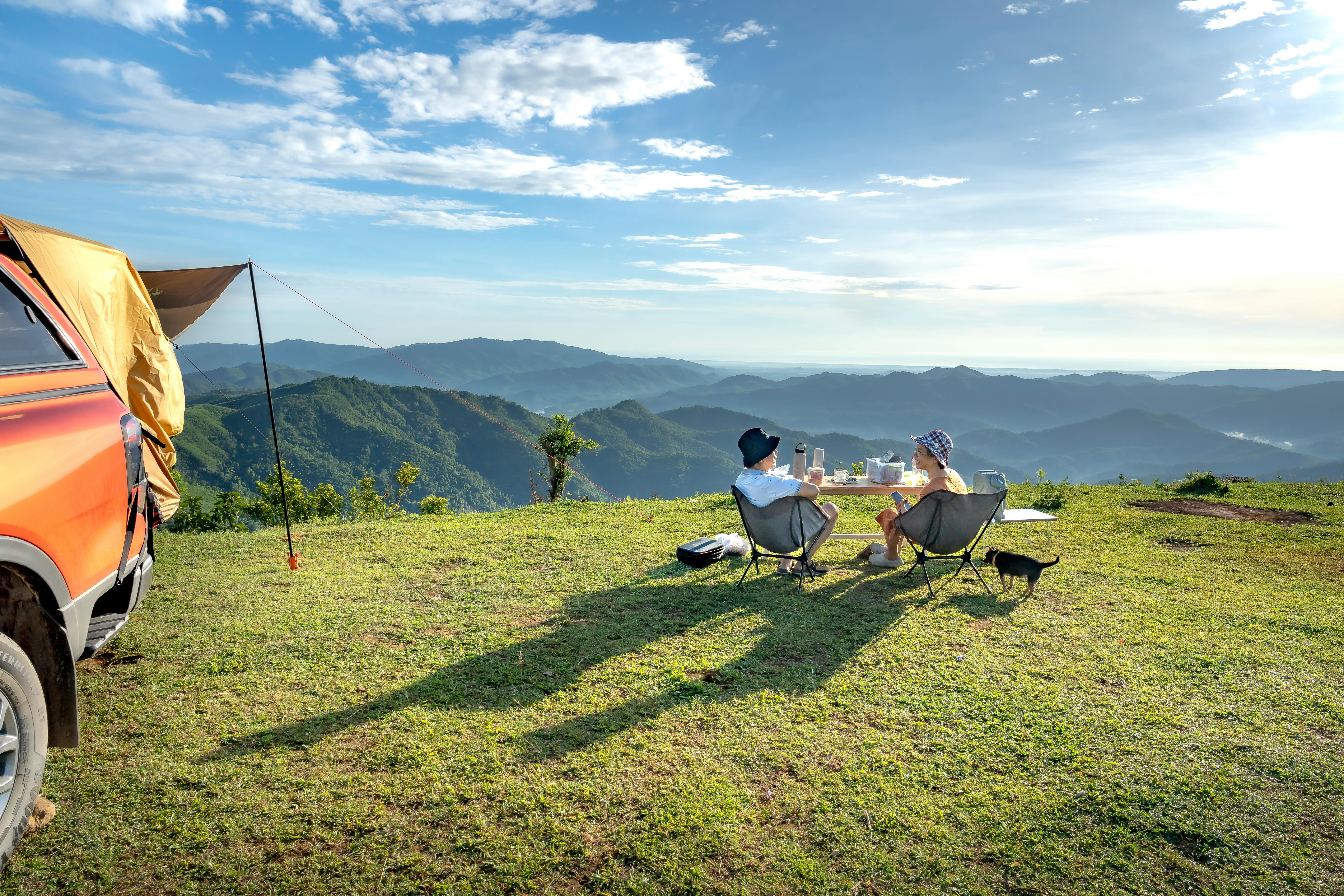 Couple Sitting on Hilltop in Countryside