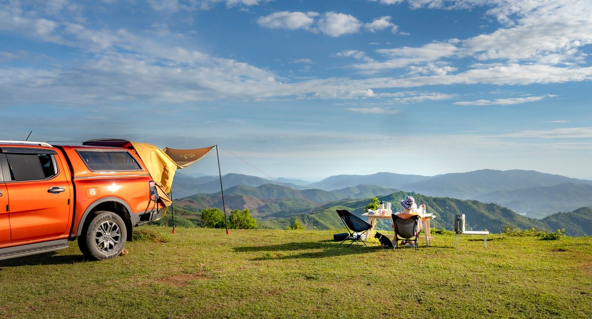Portable camp chairs and table at an overlanding campsite