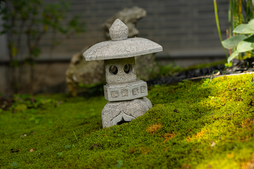 Free A tranquil garden scene featuring a stone lantern on lush green moss, perfect for zen ambiance. Stock Photo