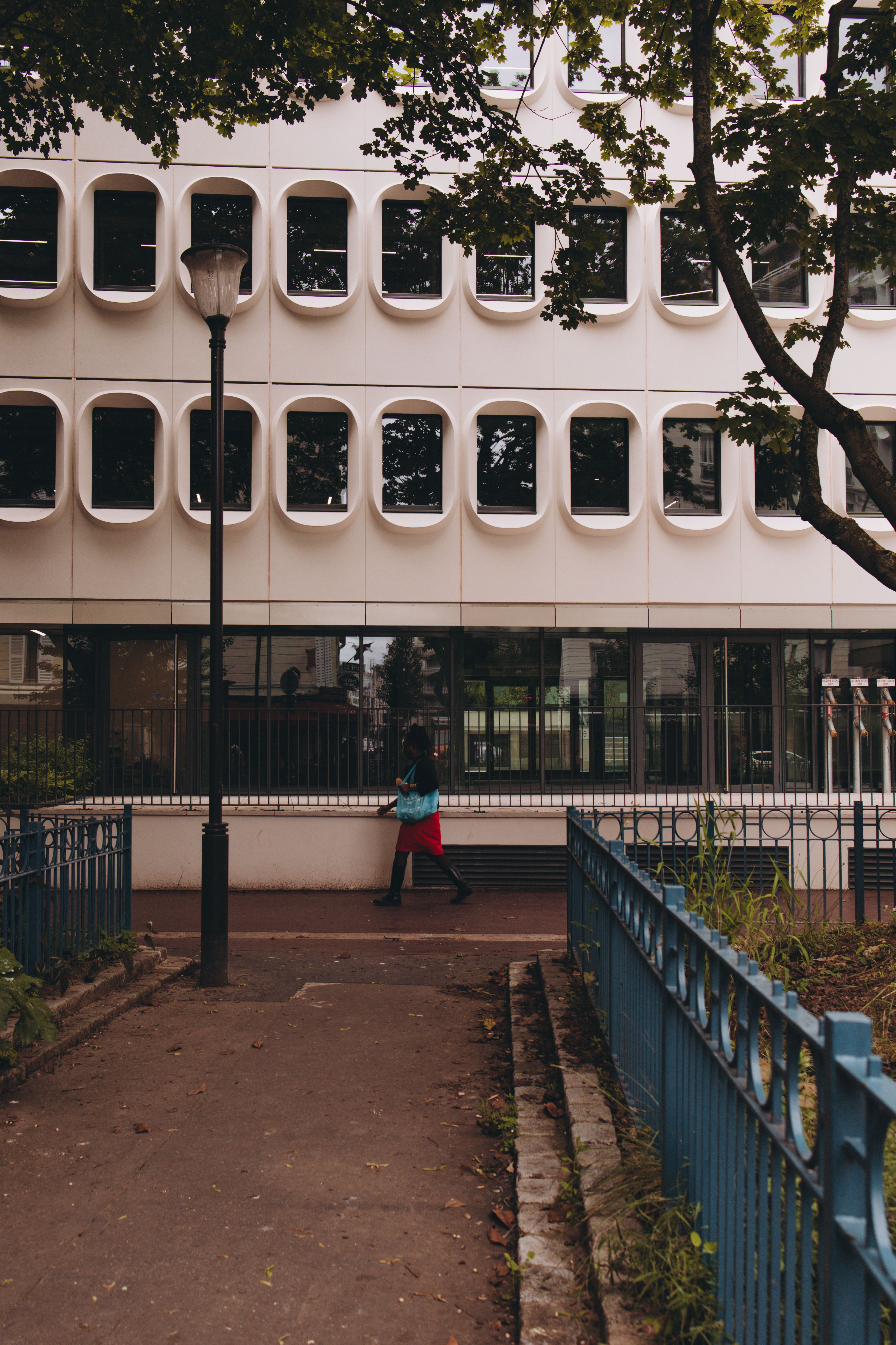 Woman Walking Past a Building · Free Stock Photo