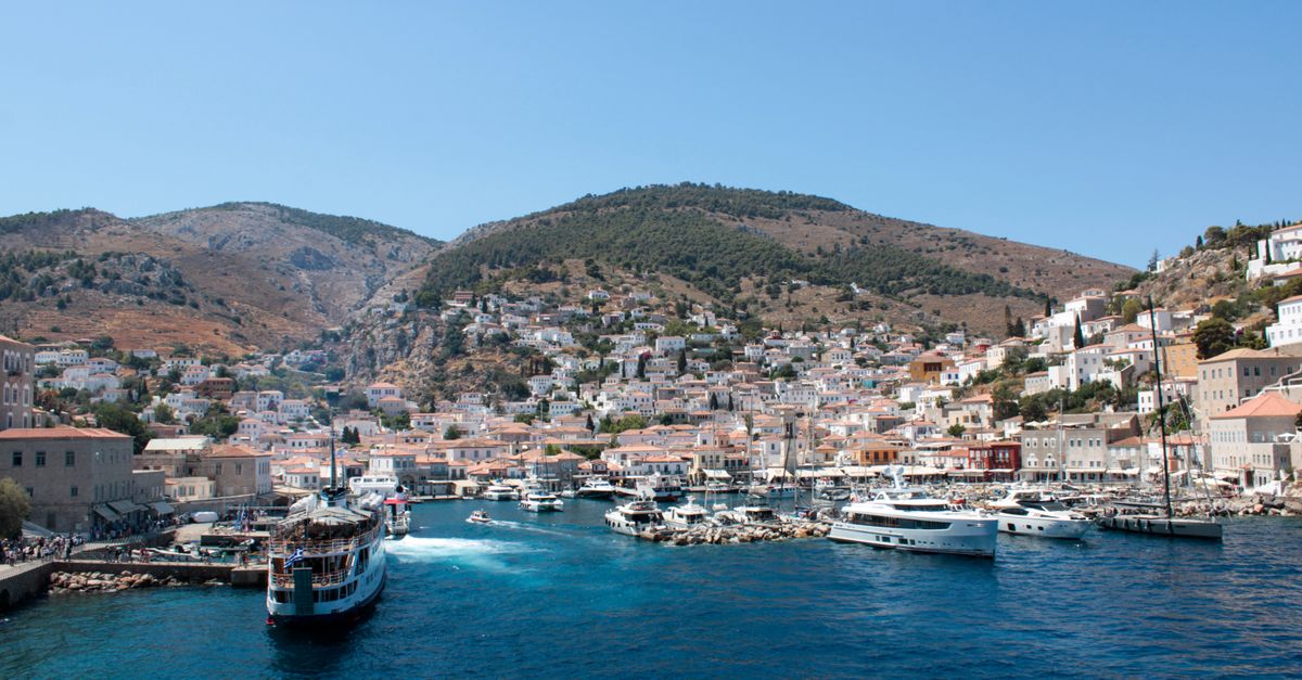 Boats and stone houses around the harbour of Hydra