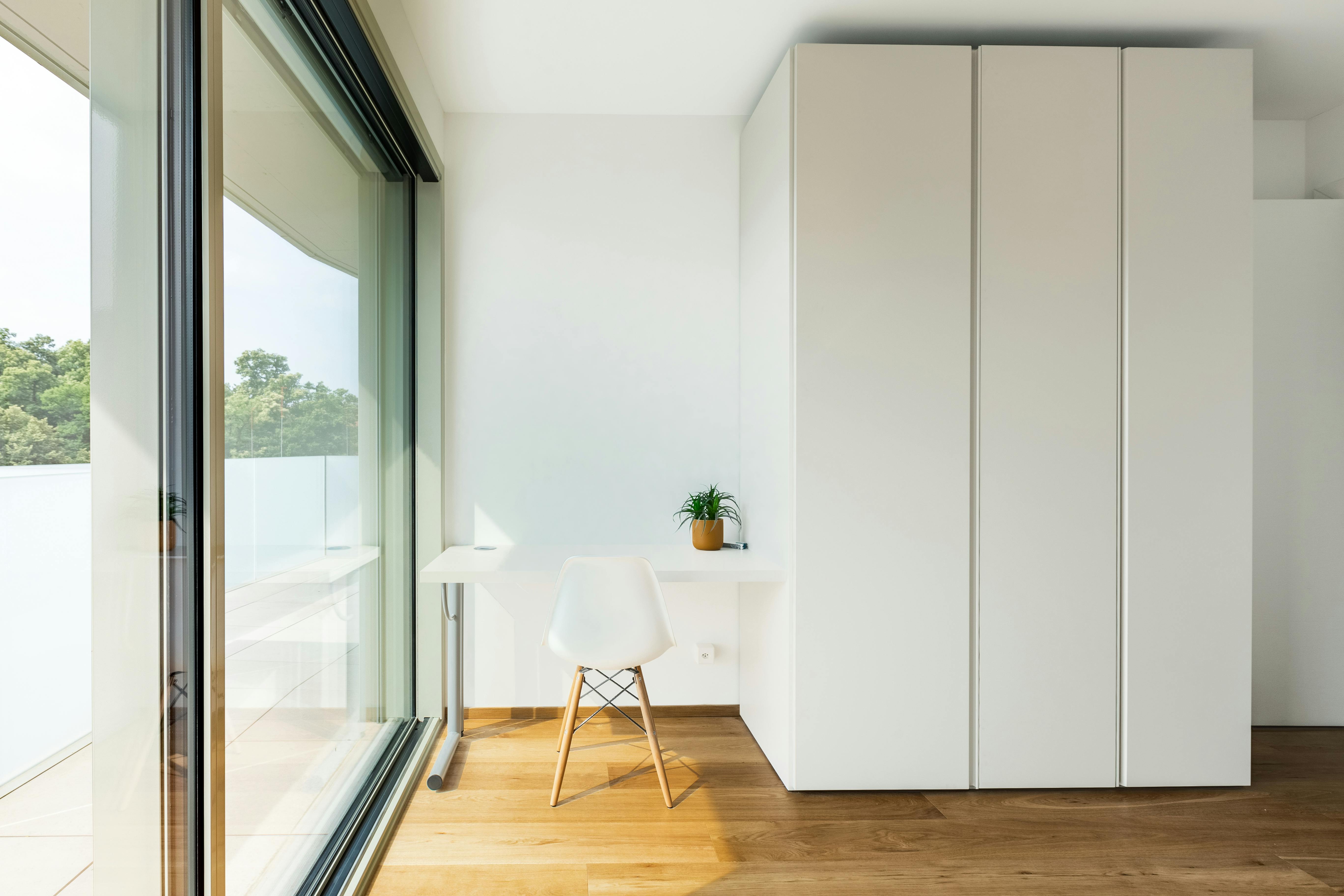 Bright minimalist home office with large window and scenic outdoor view. Ideal for productivity.