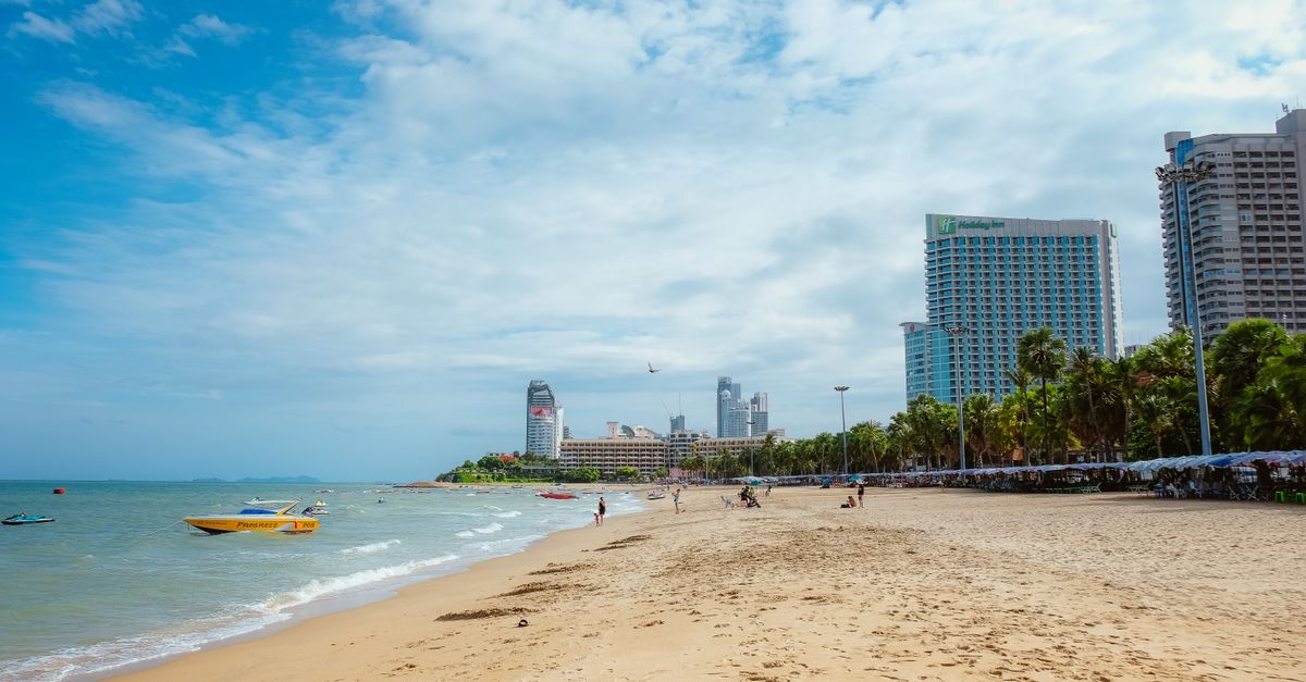 Vibrant city skyline meets tropical beach for the perfect vacation scene.