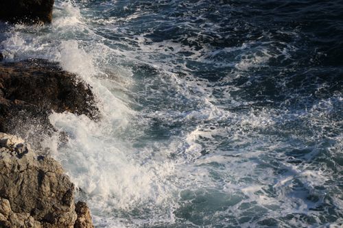 Free Dramatic waves crash against the rugged rocky coastline, showcasing nature's power. Stock Photo