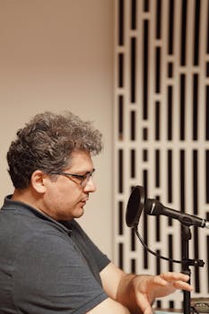 Professional radio presenter speaking into a microphone during a live session in a studio.