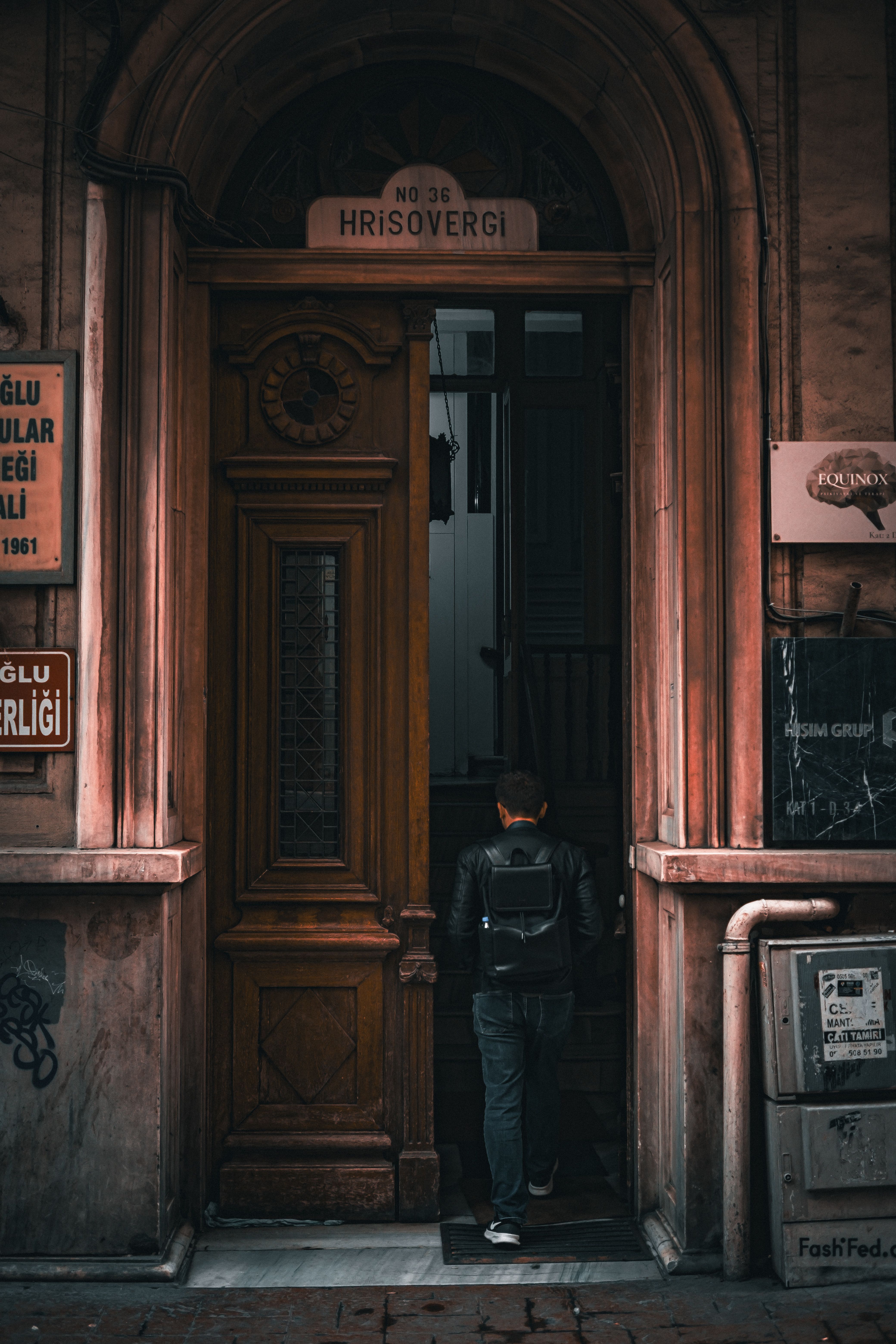 Back View of a Man Walking through the Door of an Old Building · Free ...