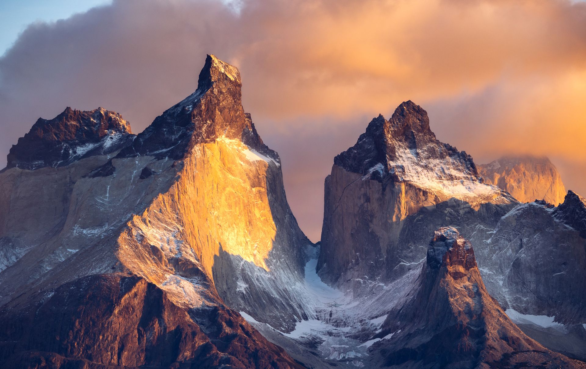 Sunset Clouds Above Snow Covered Mountains in Torres del Paine National Park, Chile