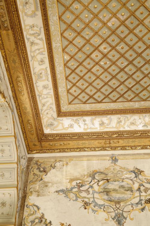 Free Luxurious and historical ornate ceiling with intricate gold decorations in an interior setting. Stock Photo