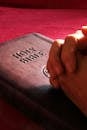 Person Hands on Holy Bible