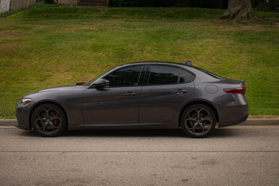 Gray sedan parked at the curb — Owen.outdoors on Pexels