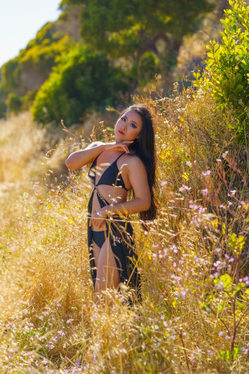 Free Elegant model posing in lingerie surrounded by wildflowers in Albany, CA meadow. Stock Photo