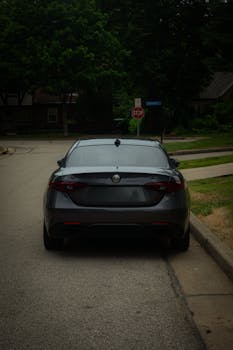 Back view of an Alfa Romeo Giulia TI parked on a calm residential street.