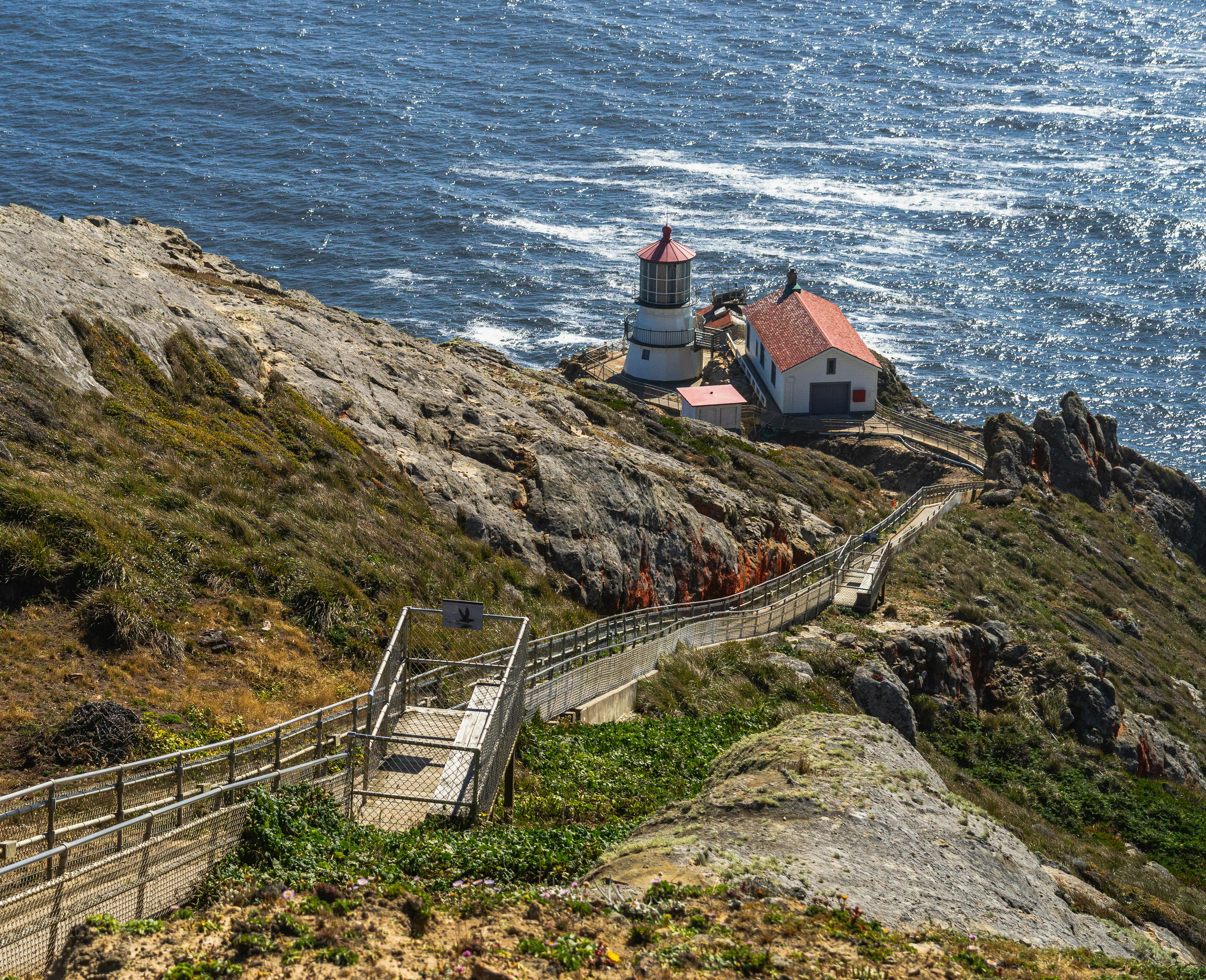 The historic Point Reyes Lighthouse perched on the cliff at the edge of the continental shelf, Marin County