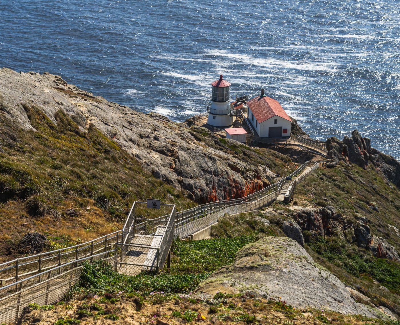 The historic Point Reyes Lighthouse perched on the cliff at the edge of the continental shelf, Marin County
