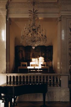 Ornate chandelier above a grand piano in a regal interior setting in Warsaw.
