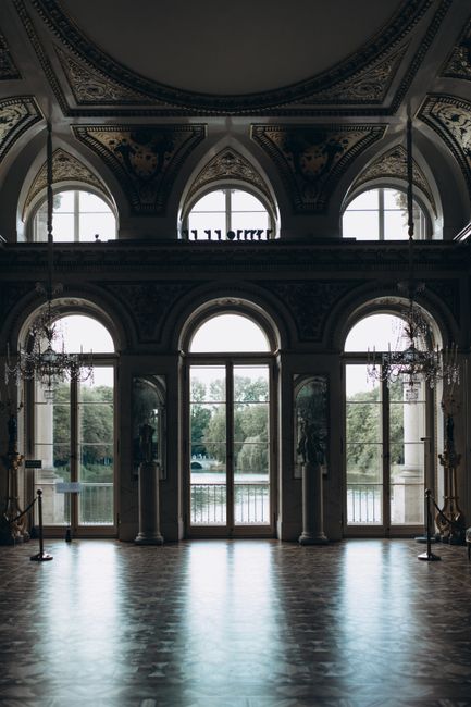 Luxurious ornate interior of the Palace on the Isle in Warsaw, Poland, showcasing grand windows and intricate details.