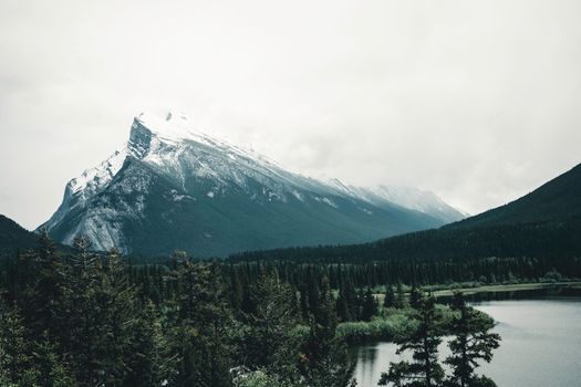 Majestic view of Mount Rundle and serene water in Banff National Park, Alberta, Canada.