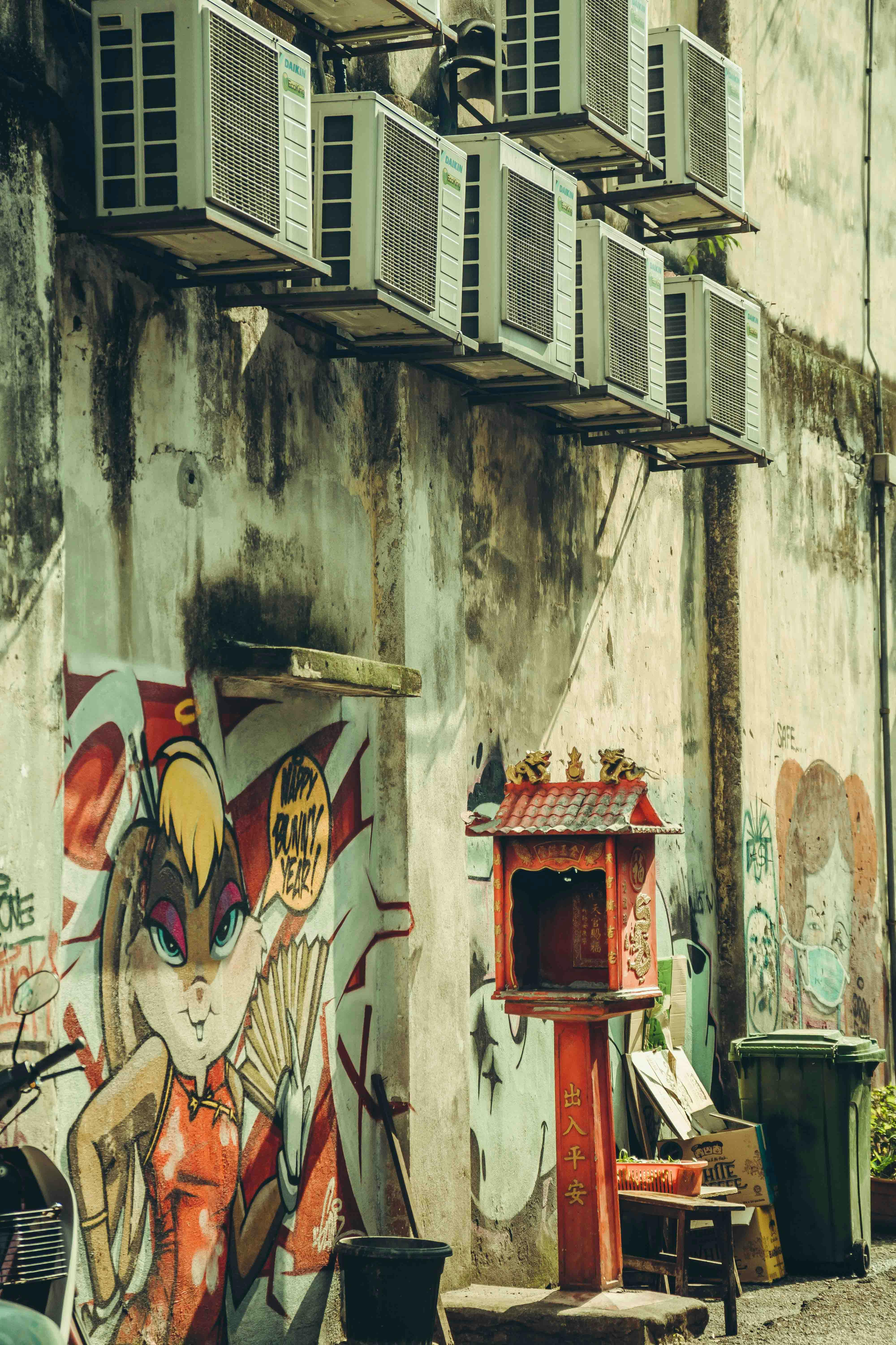 A wall with graffiti and air conditioning units · Free Stock Photo