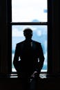 Silhouette of Man in Front of a Window