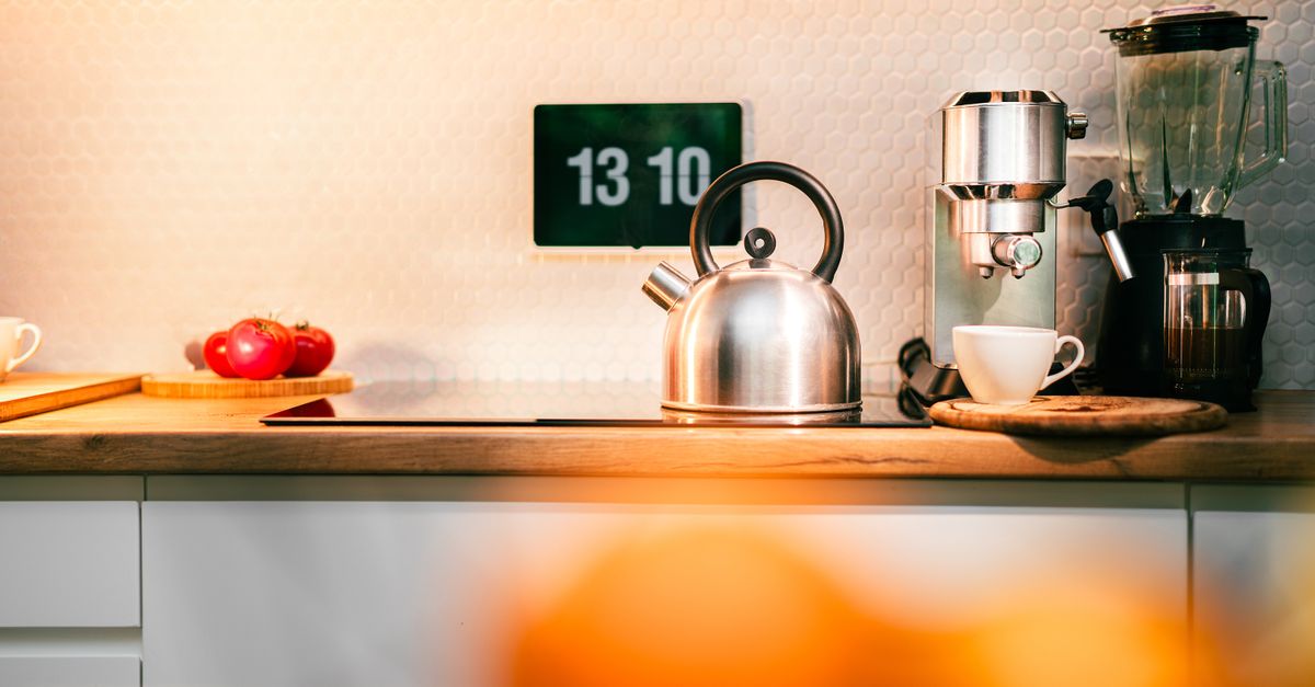 a clock showing 9 AM with a steaming coffee cup next to a sunrise