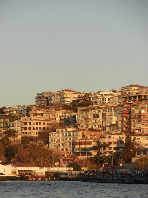 Free Charming Istanbul hillside with residential buildings during sunset, showcasing cityscape and coastal beauty. Stock Photo