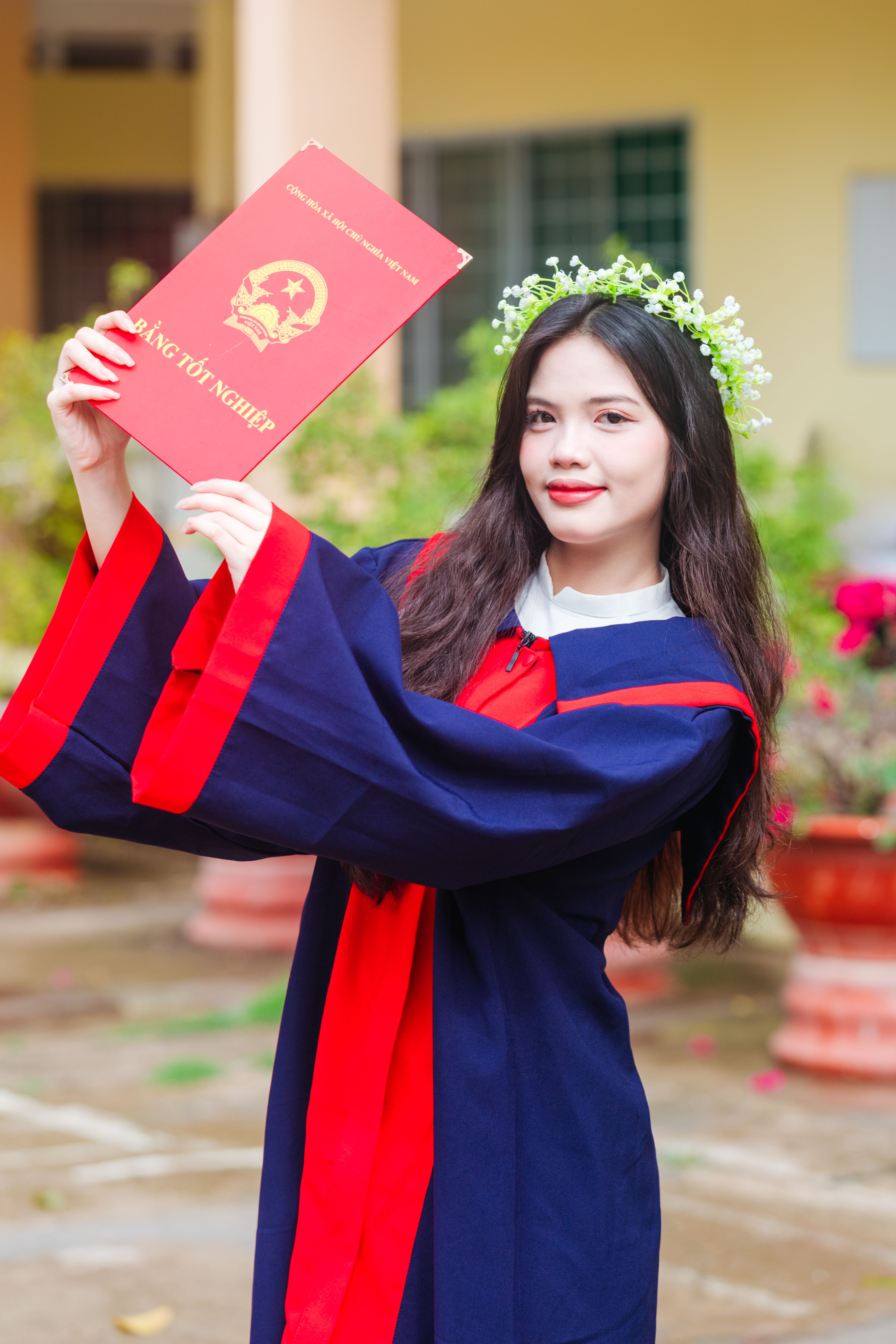 Portrait of Woman in Graduation Gown and with Diploma · Free Stock Photo
