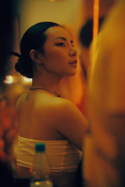 Free A serene portrait of an Asian woman with black hair in a cozy indoor setting, exuding elegance. Stock Photo