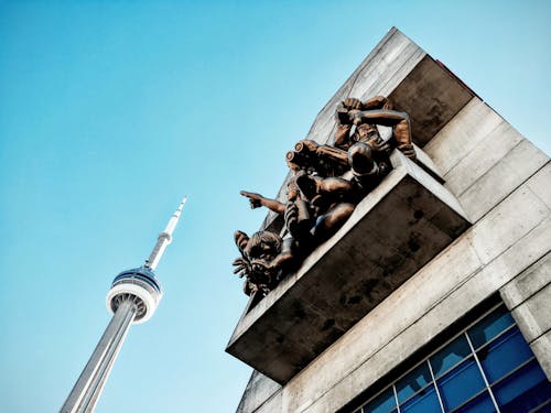 Low angle photography of statues on a wall 