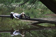 Woman Lying on Tree Near Awter