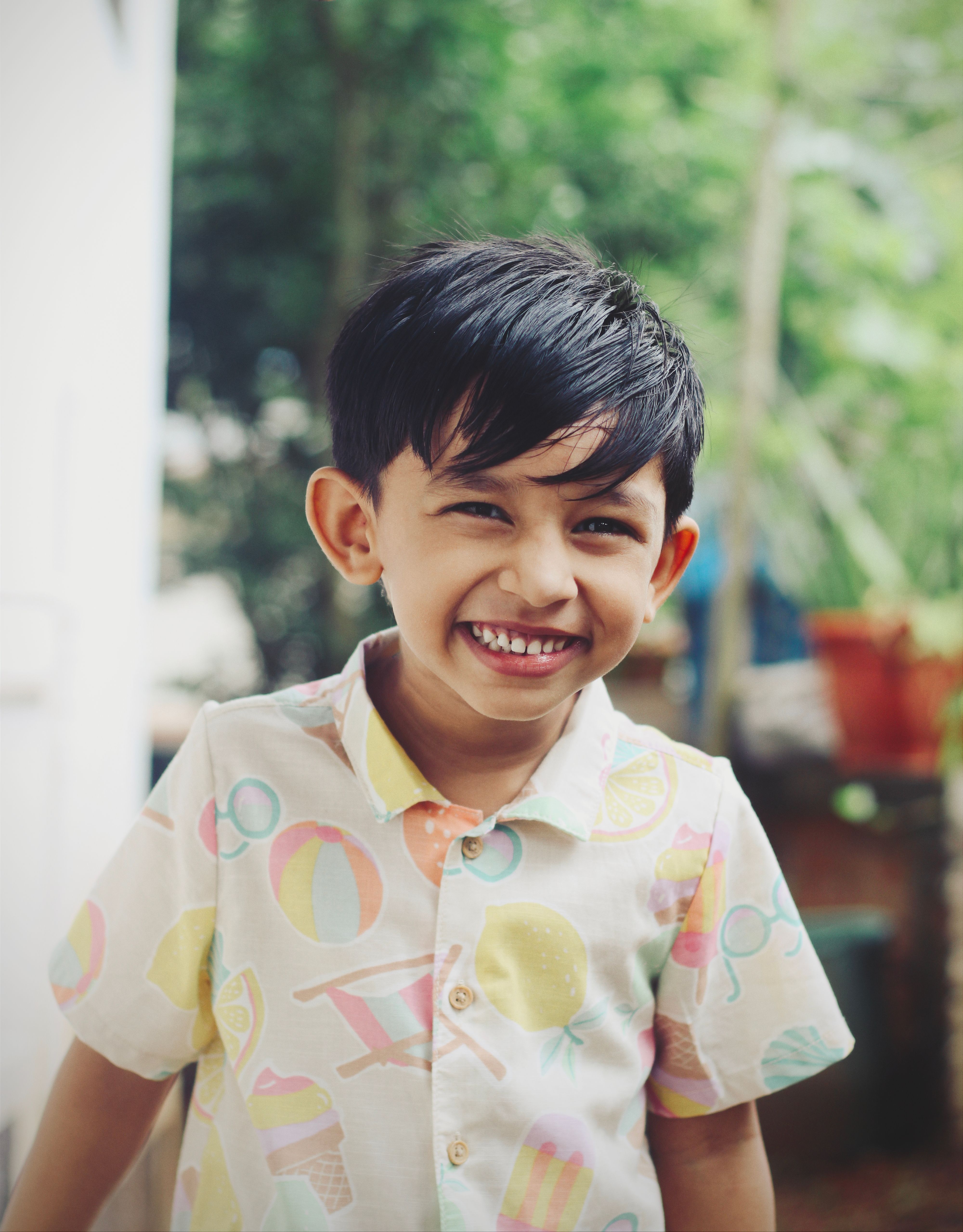 Cheerful young boy smiling in an outdoor setting in Nilambur, showcasing innocence and happiness.