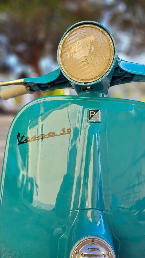 Free Close-up of a turquoise Vespa scooter in Agropoli, Italy. Stock Photo