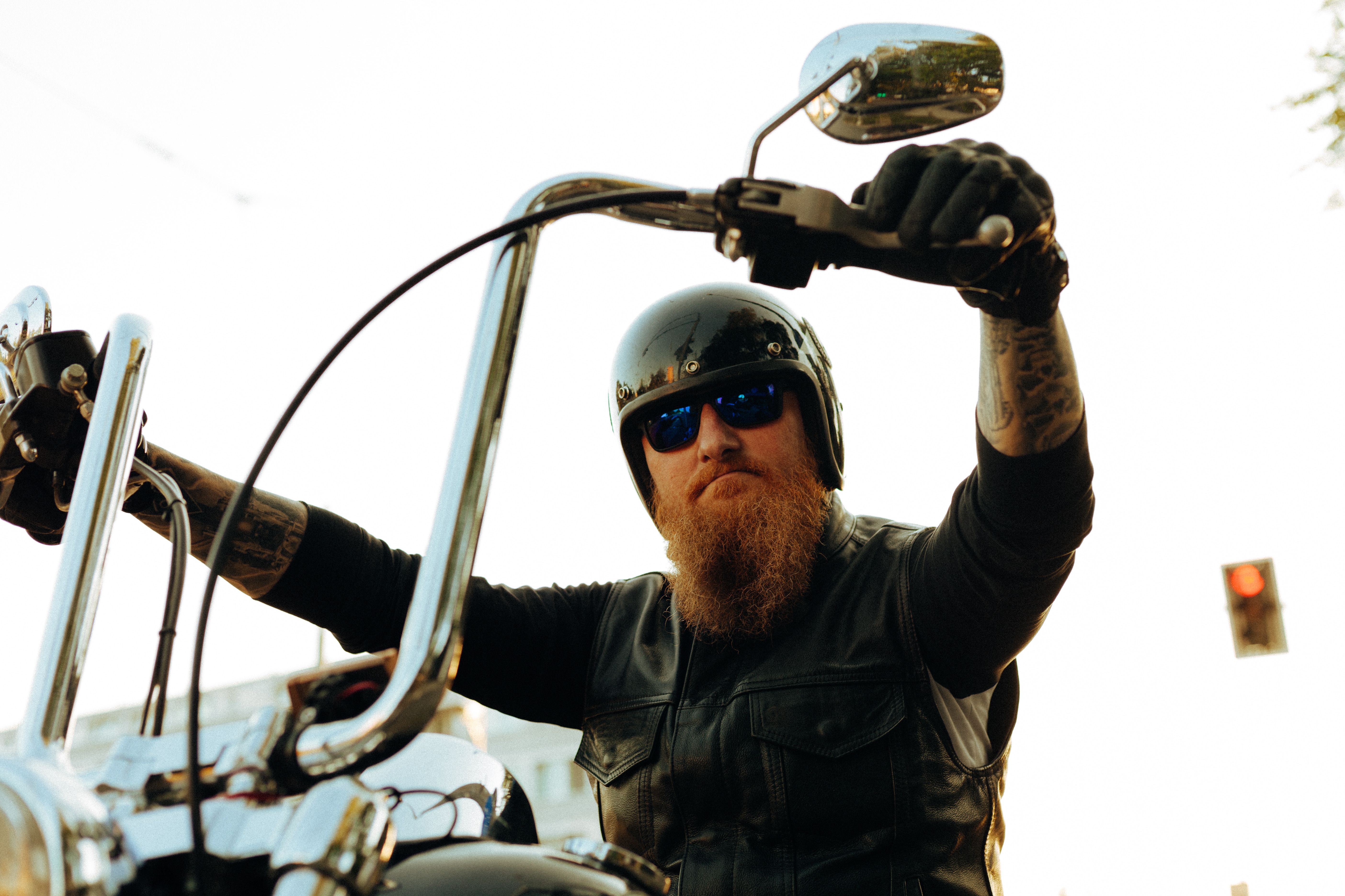 Portrait of a Bearded Man Sitting on a Motorcycle · Free Stock Photo
