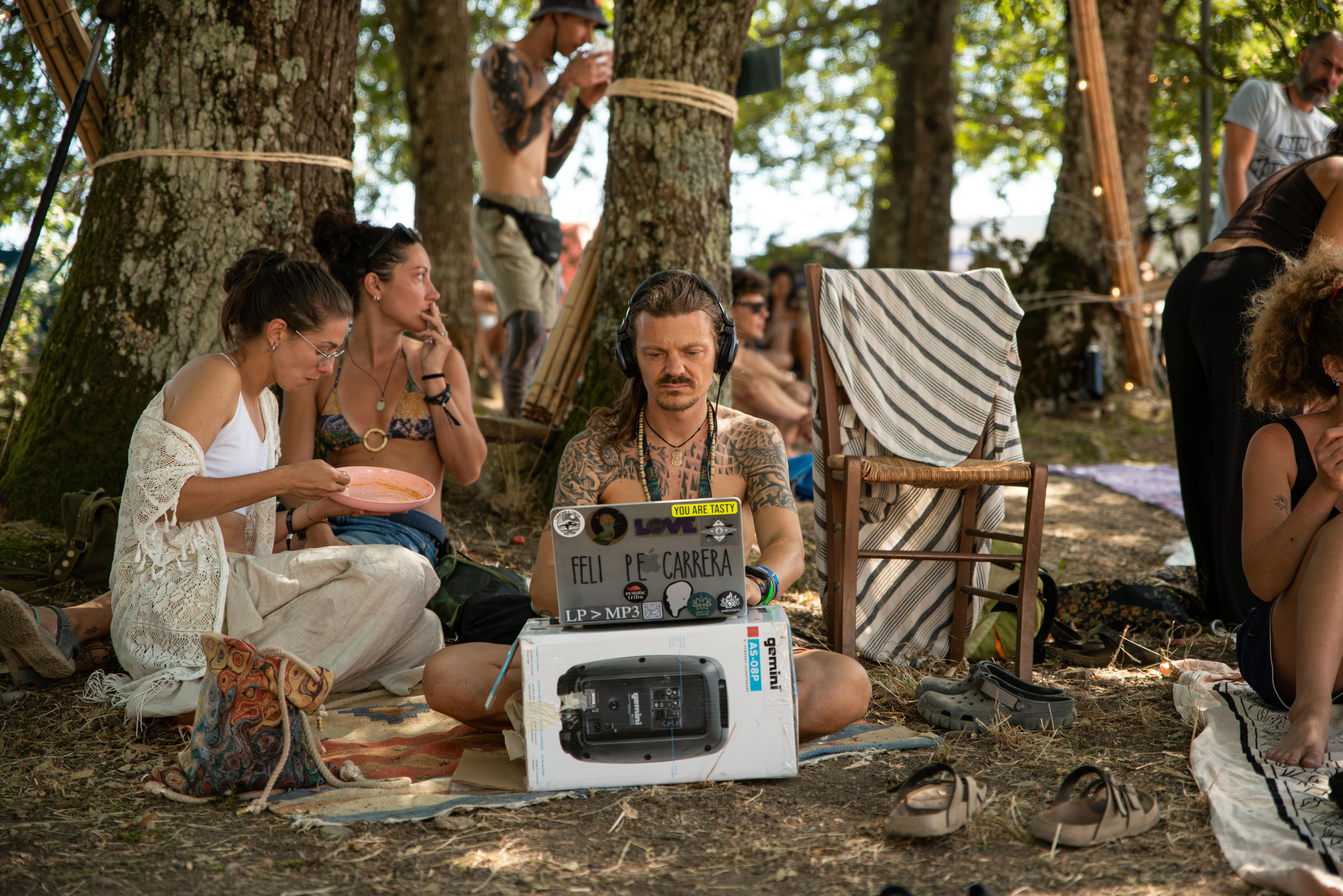 people relaxing among trees in summer