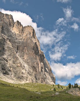 Majestic rocky cliff in Selva di Val Gardena, Italy under a clear blue sky. Perfect for travel and nature scenes.