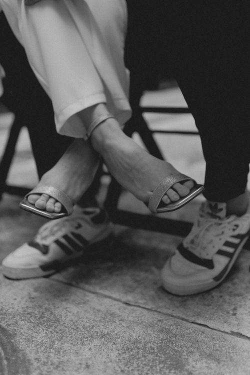 Free Black and white image showcasing footwear contrast with sandals and sneakers. Stock Photo