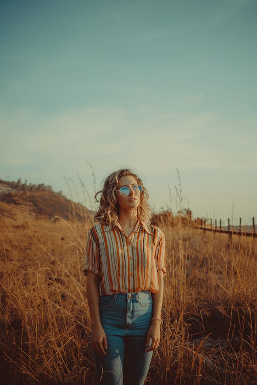 Free Photo of Woman Standing on Grass Field Stock Photo