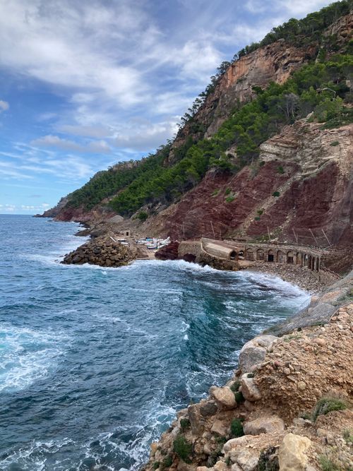 Free Stunning view of Cala Estellencs, Spain with rocky cliffs and vibrant sea. Stock Photo