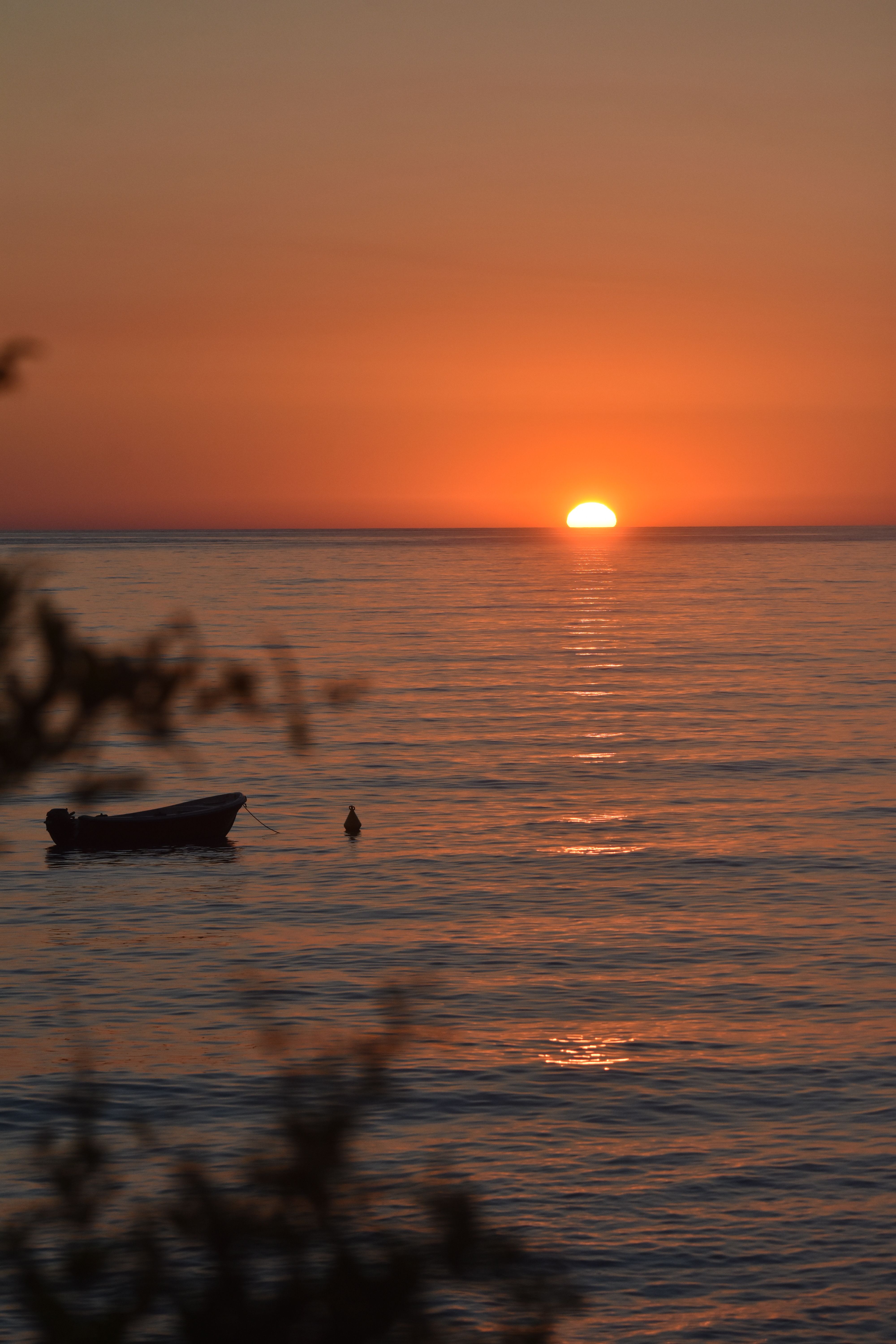 Silhouette of Men on a Boat During Sunset · Free Stock Photo