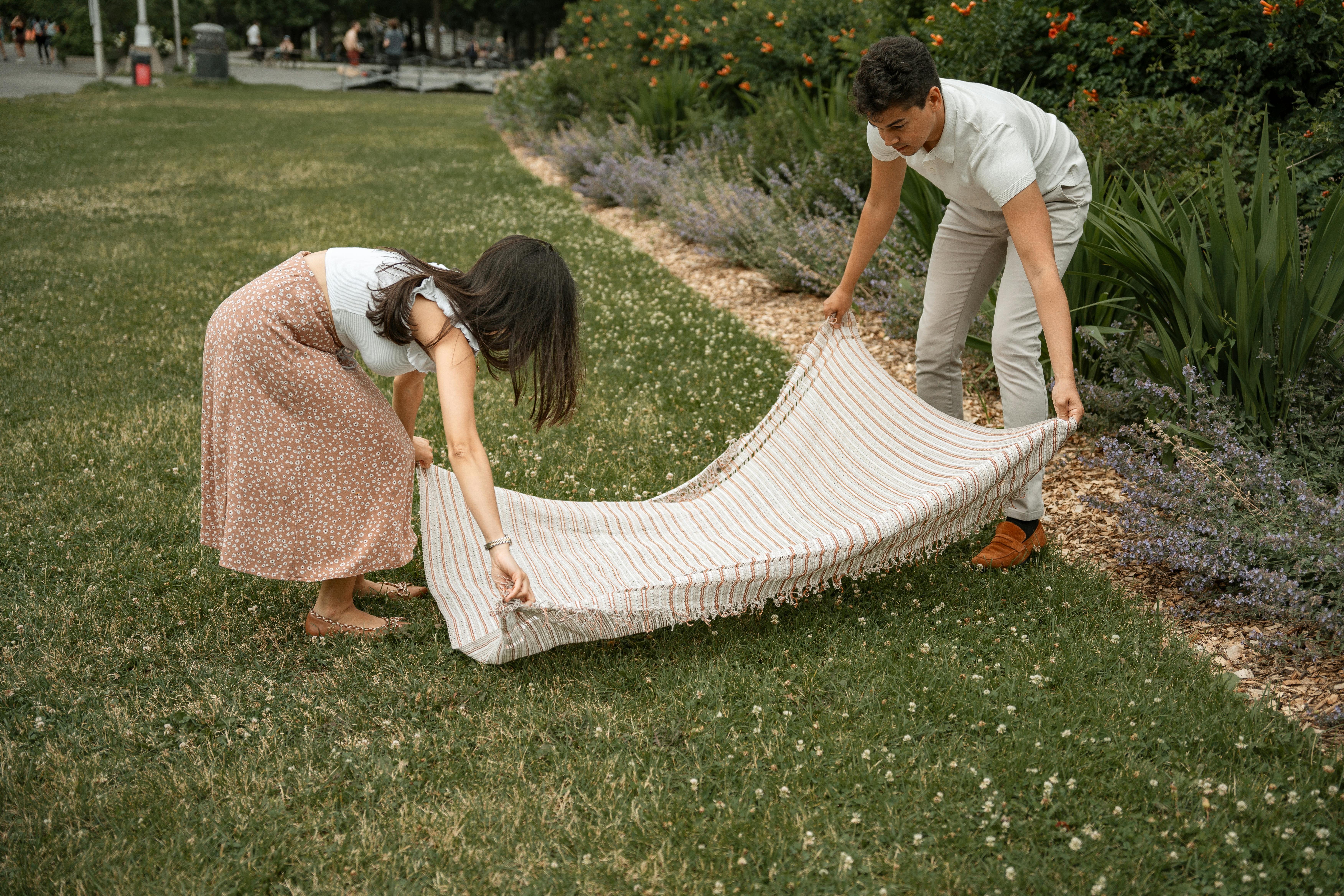 a couple with a blanket in a park