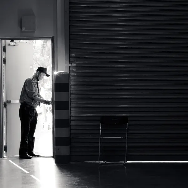 A security guard standing at an open doorway, representing WP Guardian blocking exploit attempts at the entrance to your WordPress site