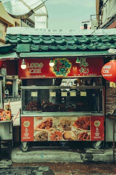 Explore the vibrant atmosphere of an Asian street food stall in a bustling city street.