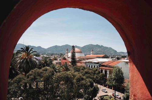 Free A stunning view of Huauchinango, Mexico with a historic church framed by vibrant nature and mountains. Stock Photo