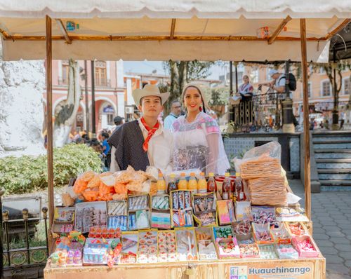 Free Vibrant street vendors selling traditional sweets in Huauchinango, Mexico market. Stock Photo
