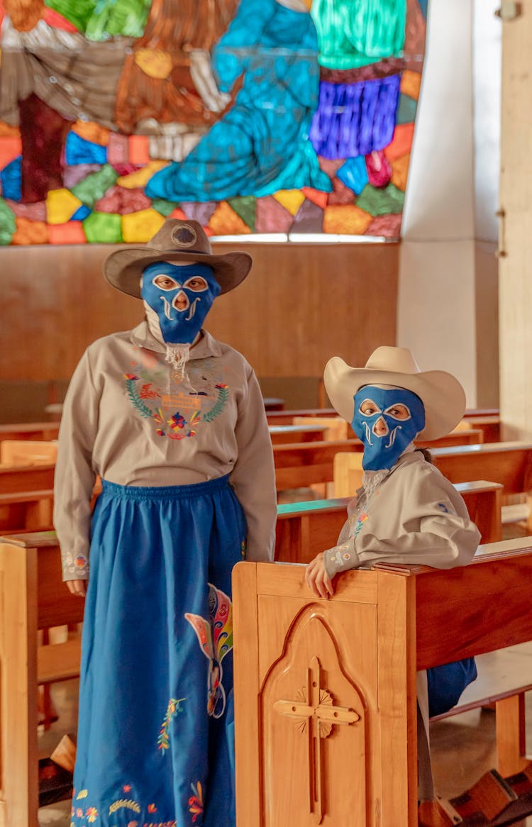 People In Traditional Clothing And Masks At Church