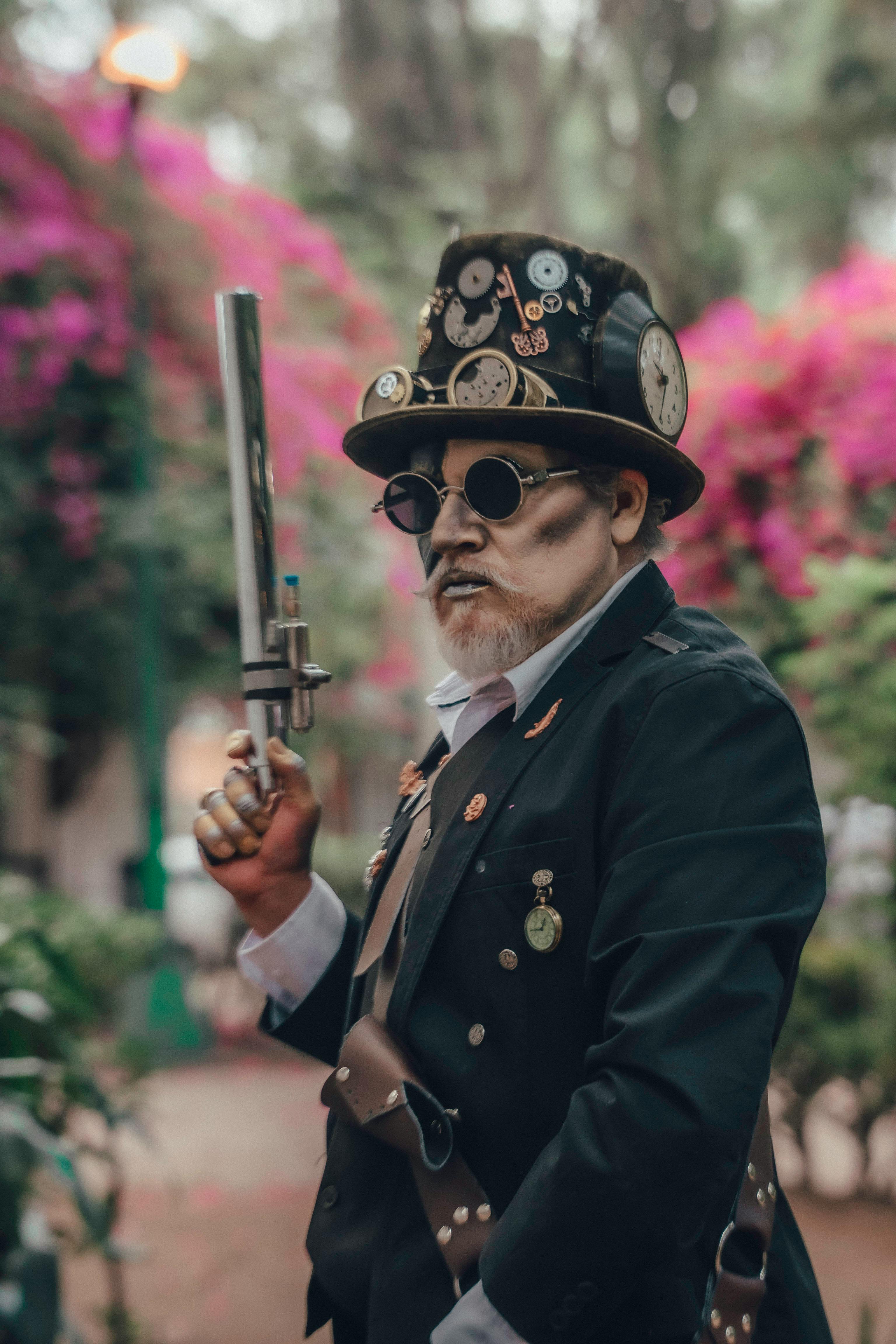 Man in steampunk costume holding weapon in vibrant floral Ciudad de México outdoor setting.