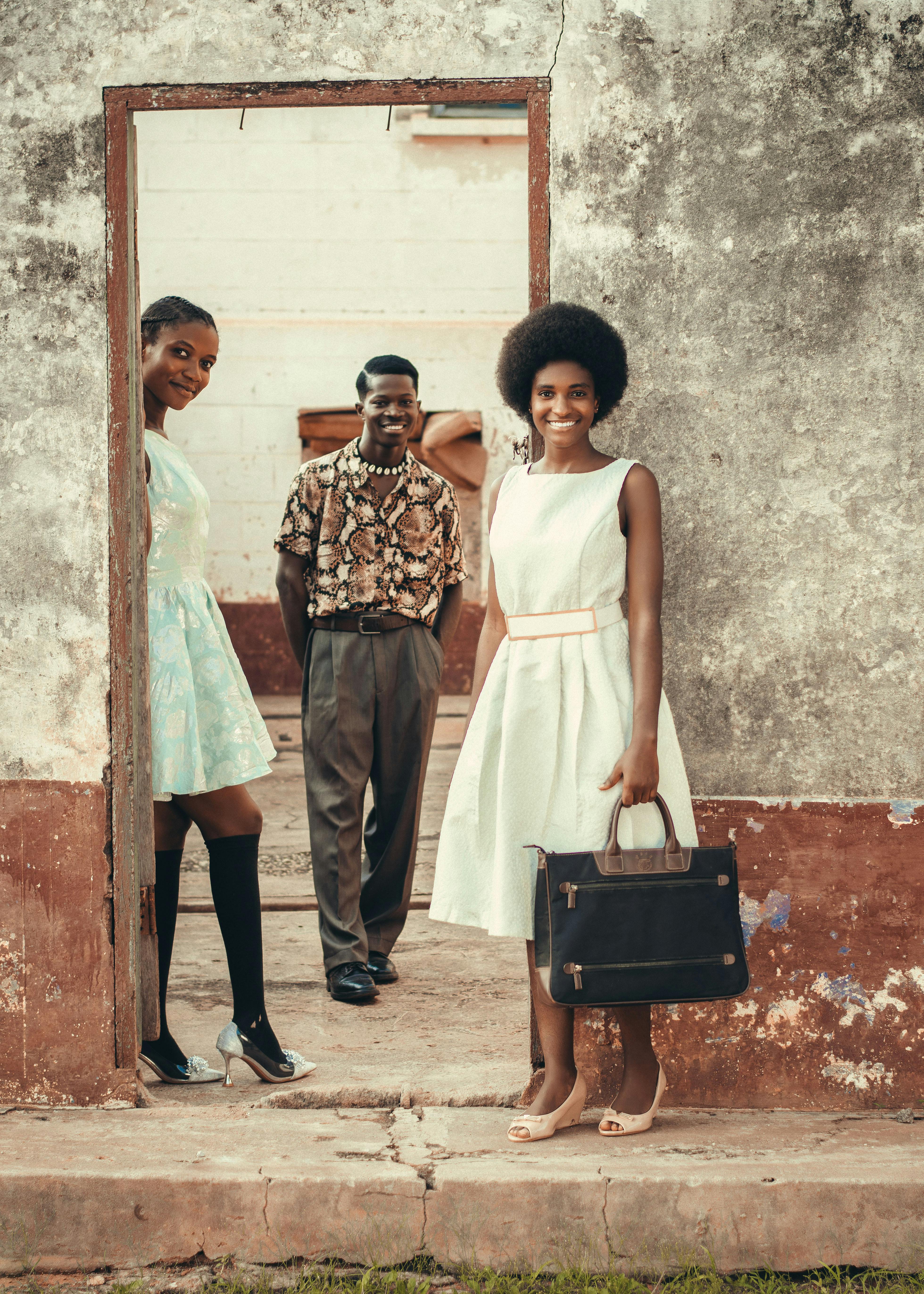 two women and a man on a street