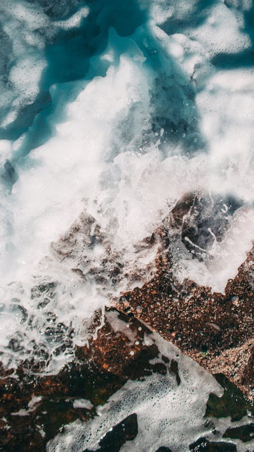 Foamy Water and Ice on the Rock