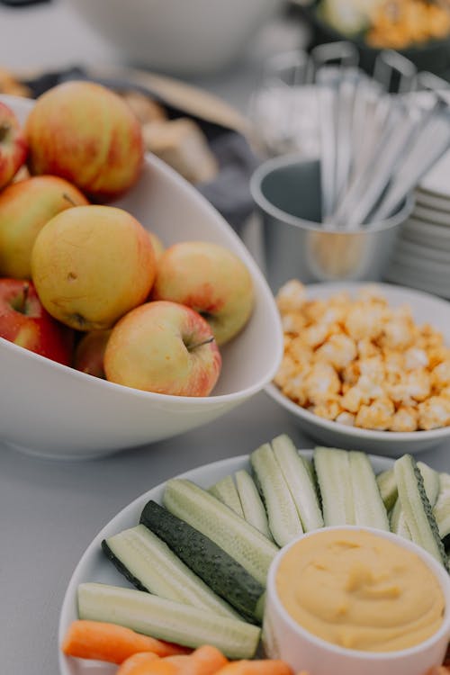 Free A table with apples, carrots, and dip Stock Photo